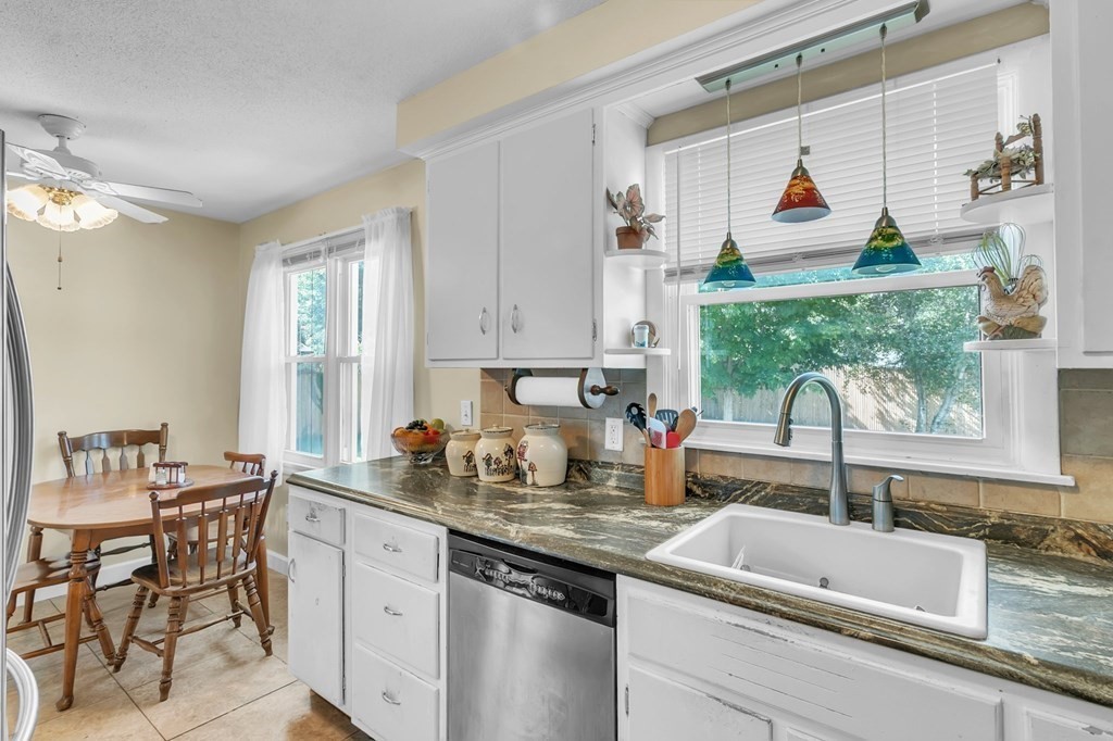 48 Greenlawn Street Springfield, MA 01119 - Photo 13 of 39 a kitchen with sink a window and chairs