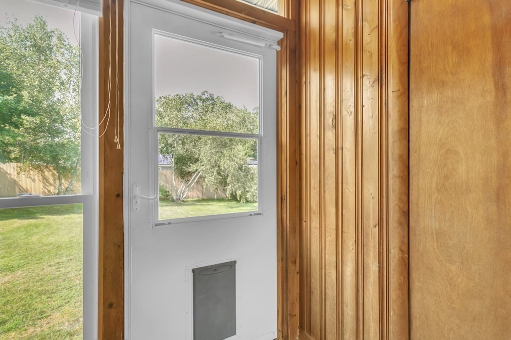 48 Greenlawn Street Springfield, MA 01119 - Photo 14 of 39 a view of a room that has a large window and a yard