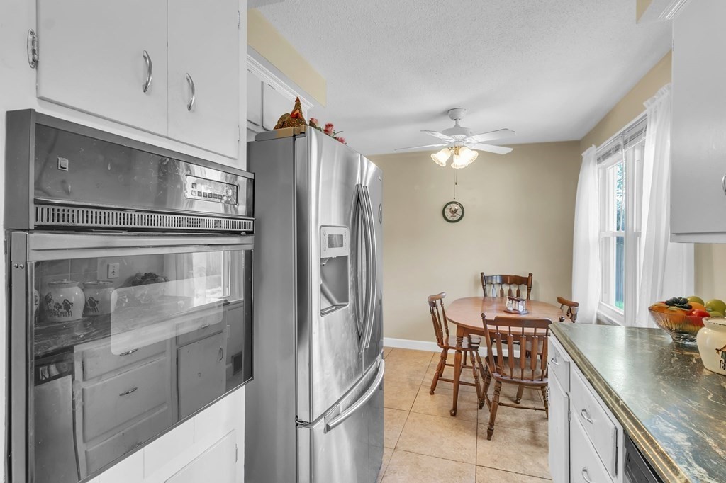 48 Greenlawn Street Springfield, MA 01119 - Photo 22 of 39 a kitchen with stainless steel appliances granite countertop a refrigerator and a stove top oven