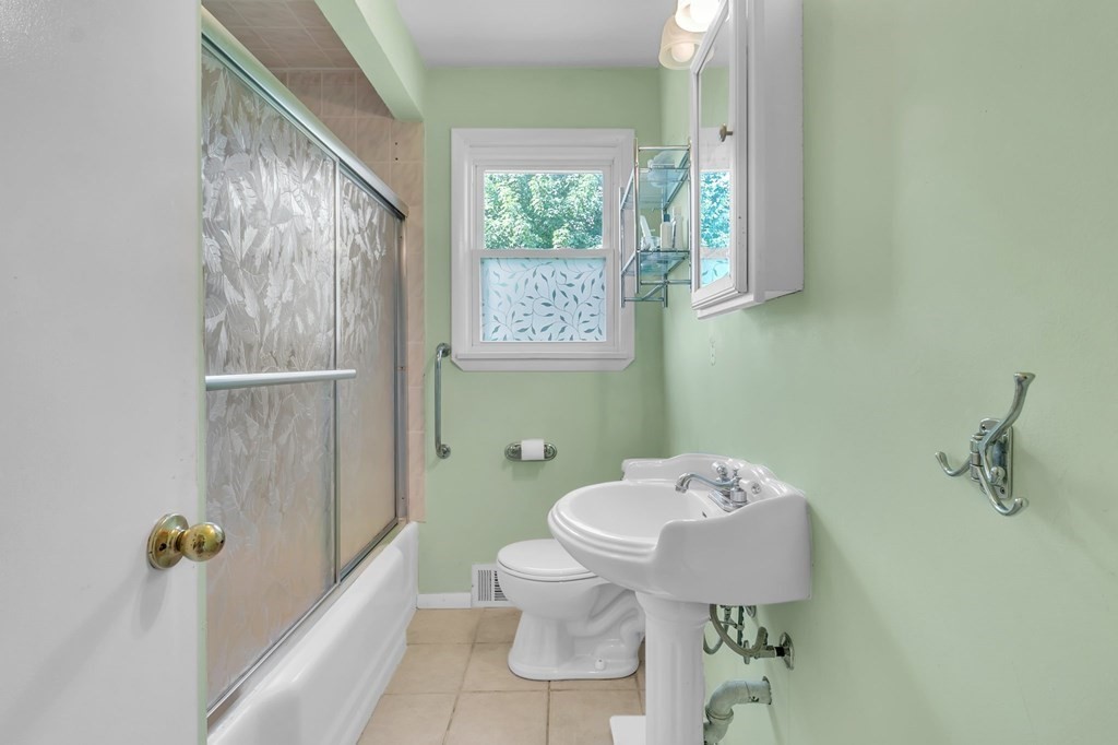 48 Greenlawn Street Springfield, MA 01119 - Photo 23 of 39 a bathroom with a toilet sink and mirror