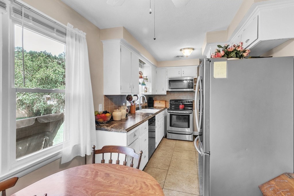 48 Greenlawn Street Springfield, MA 01119 - Photo 30 of 39 a kitchen with stainless steel appliances a stove a sink and a refrigerator