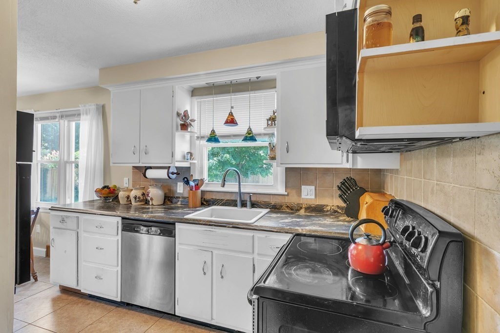 48 Greenlawn Street Springfield, MA 01119 - Photo 31 of 39 a kitchen with stainless steel appliances granite countertop a sink stove and cabinets