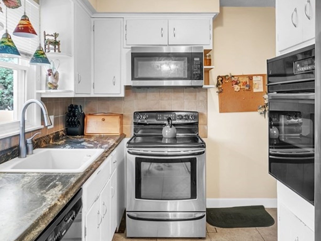 48 Greenlawn Street Springfield, MA 01119 - Photo 5 of 39 a kitchen with granite countertop a stove and a sink