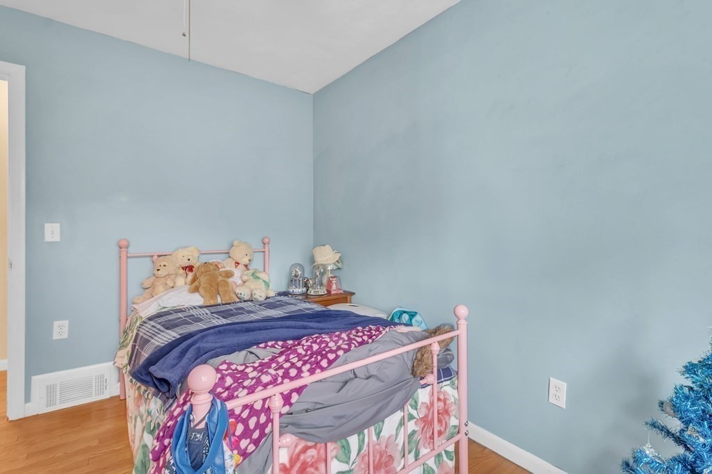 48 Greenlawn Street Springfield, MA 01119 - Photo 8 of 39 a bed with a white comforter and pillows