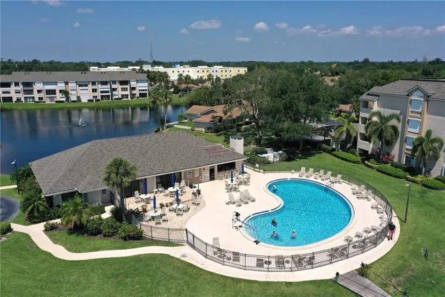 a view of a swimming pool with a yard and lake view