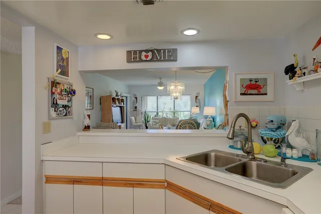 a kitchen with a sink and a refrigerator