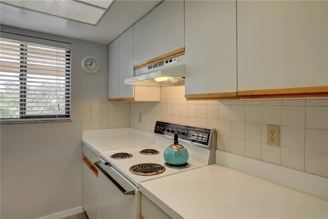 a kitchen with a stove and a microwave