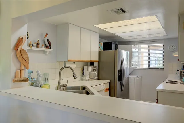 a kitchen with a refrigerator and a sink