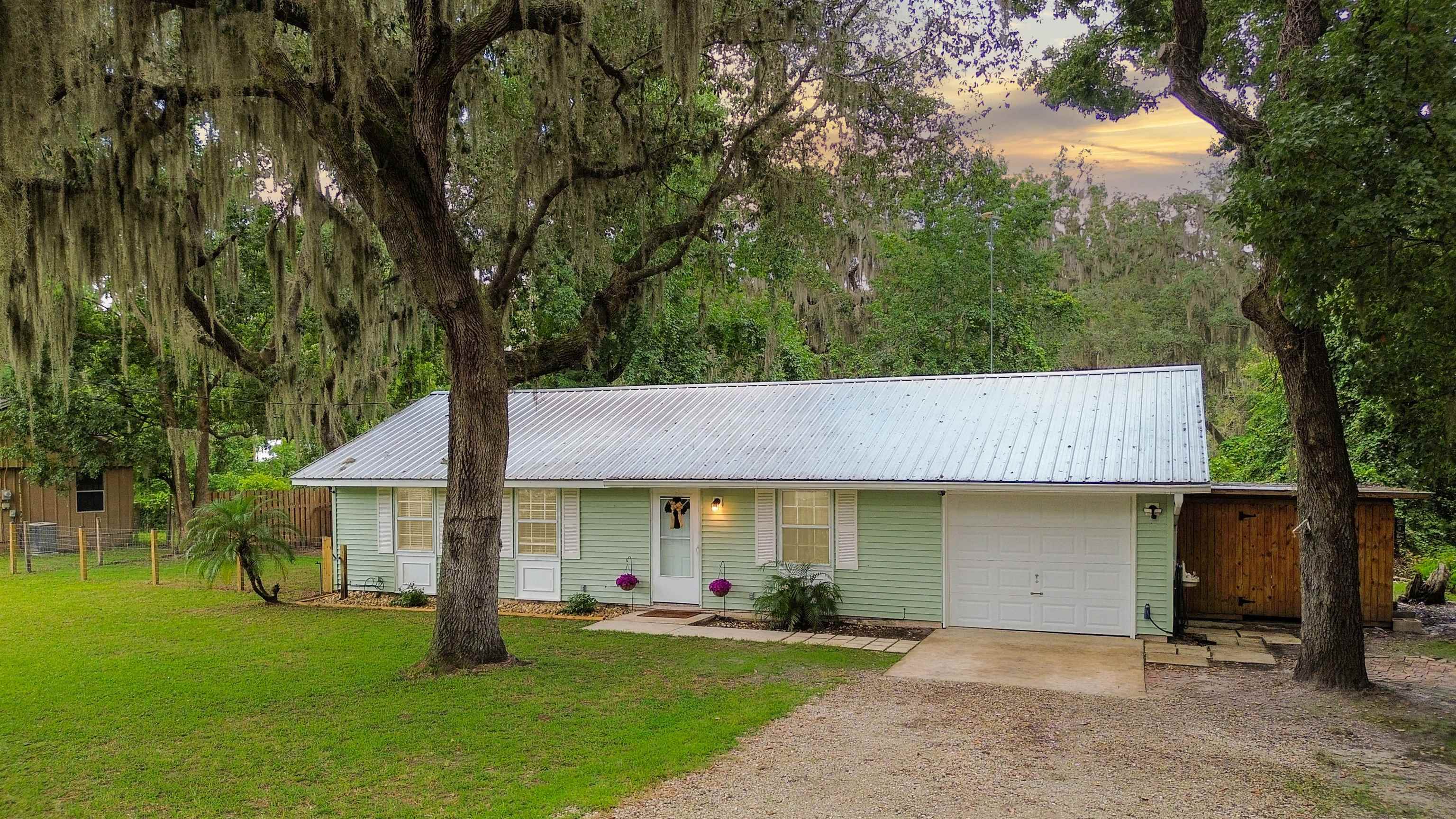 a view of a house with a yard and tree