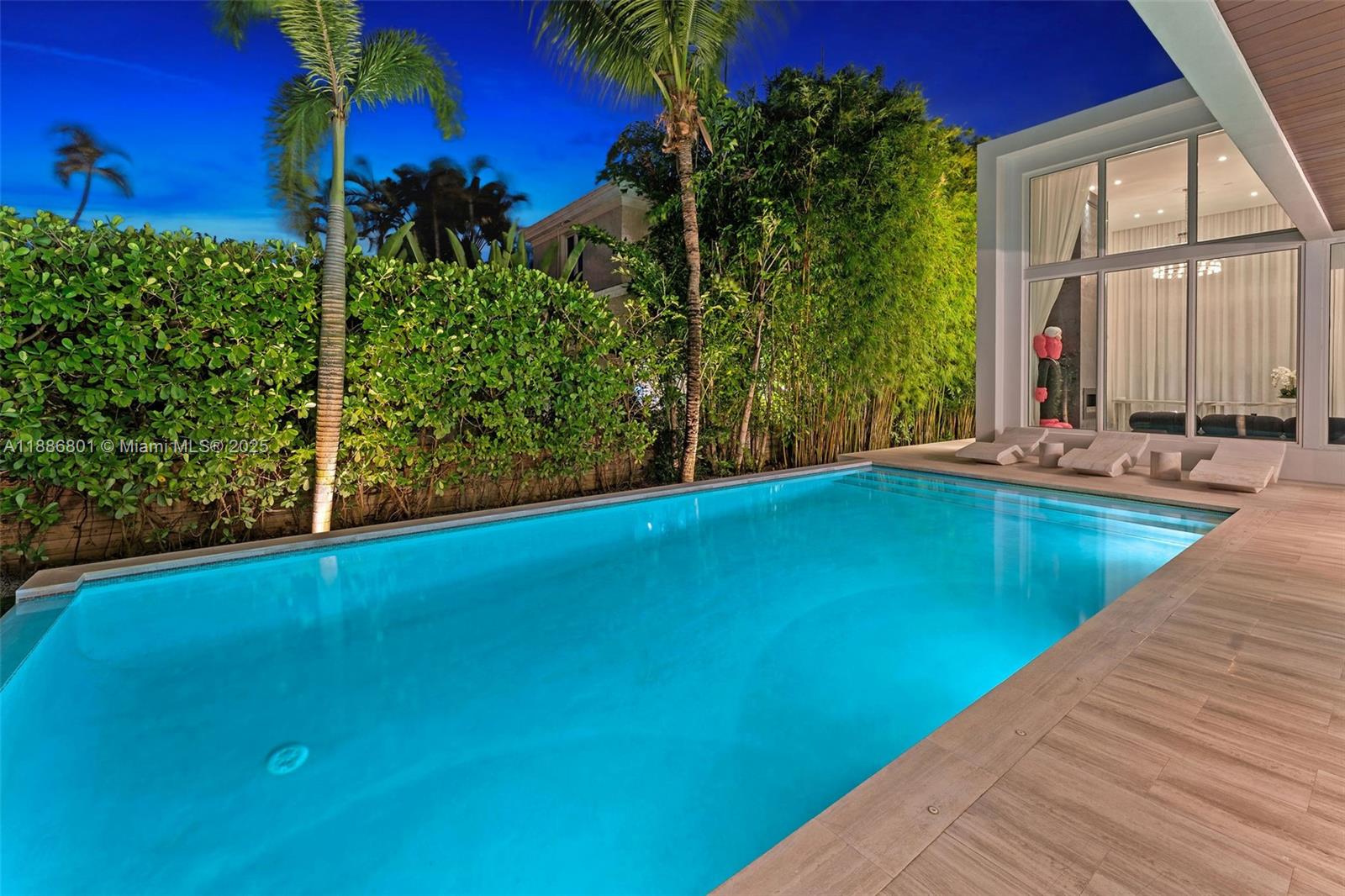 4433 North Bay Road Miami Beach, FL 33140 - Photo 21 of 71 a view of a swimming pool with an outdoor seating
