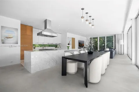 a view of a hallway with wooden floor and entryway