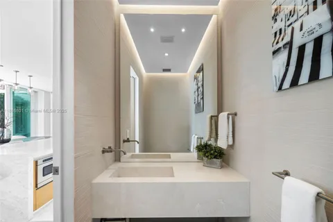 a view of a workspace with furniture and a flat screen tv