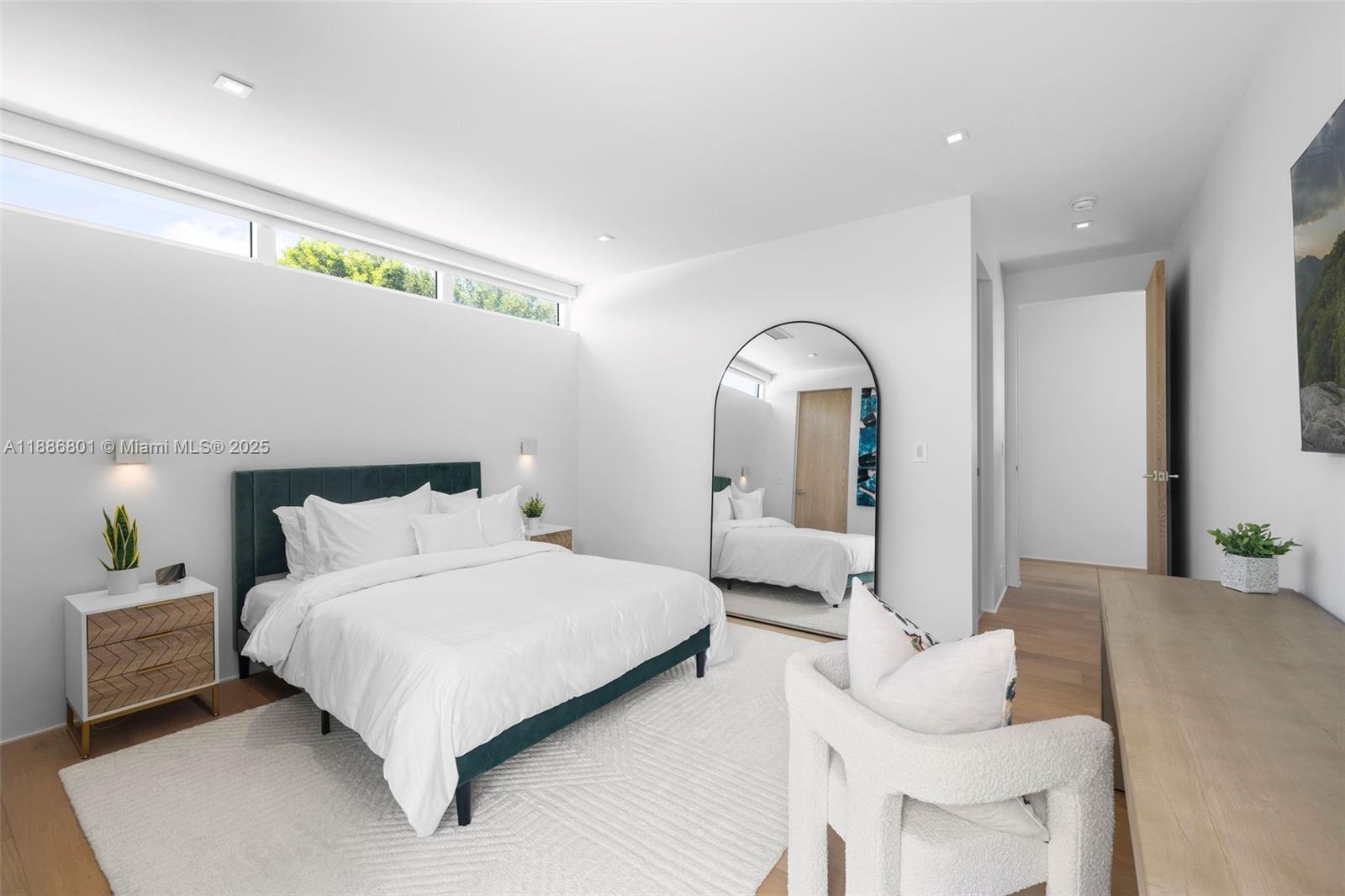 4433 North Bay Road Miami Beach, FL 33140 - Photo 47 of 71 a bedroom with a bed and a mirror