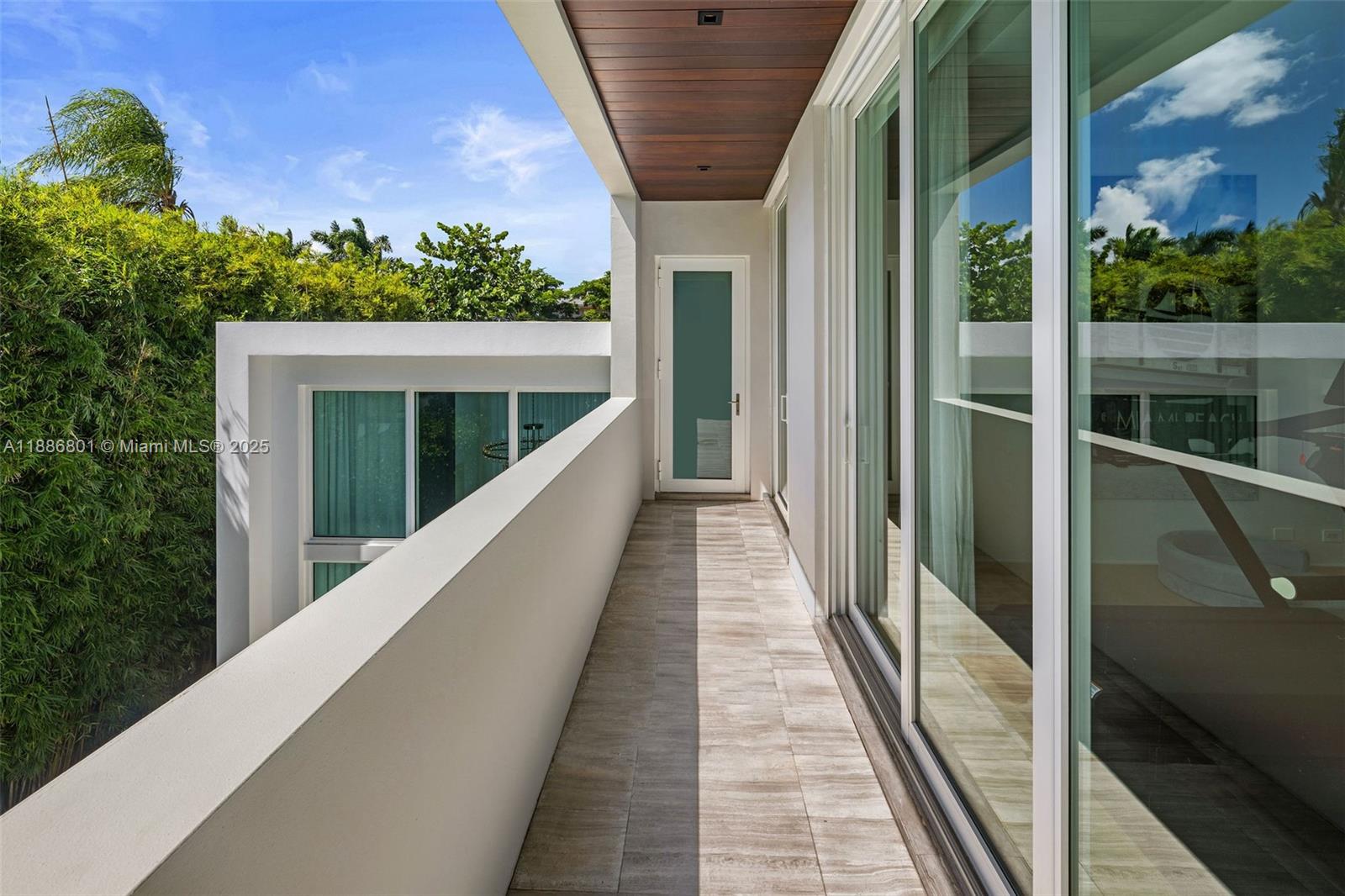 4433 North Bay Road Miami Beach, FL 33140 - Photo 51 of 71 a view of balcony with wooden floor and fence