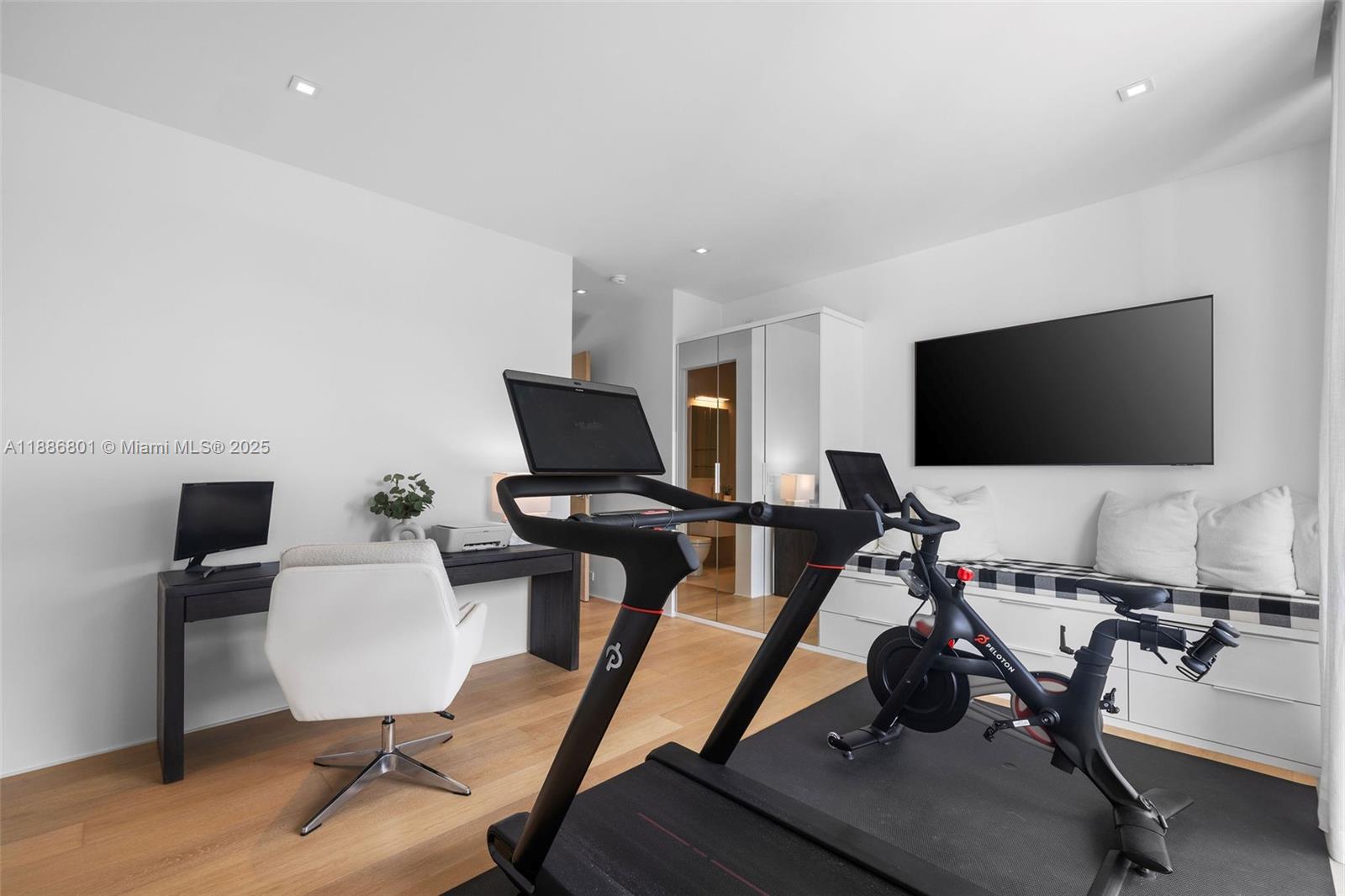 4433 North Bay Road Miami Beach, FL 33140 - Photo 55 of 71 a view of a workspace with furniture and a flat screen tv