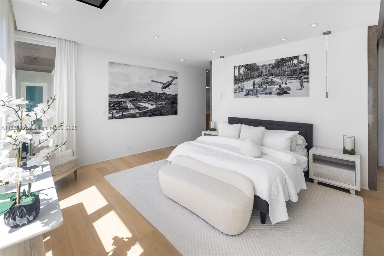 4433 North Bay Road Miami Beach, FL 33140 - Photo 58 of 71 a bedroom with a large bed and a chandelier