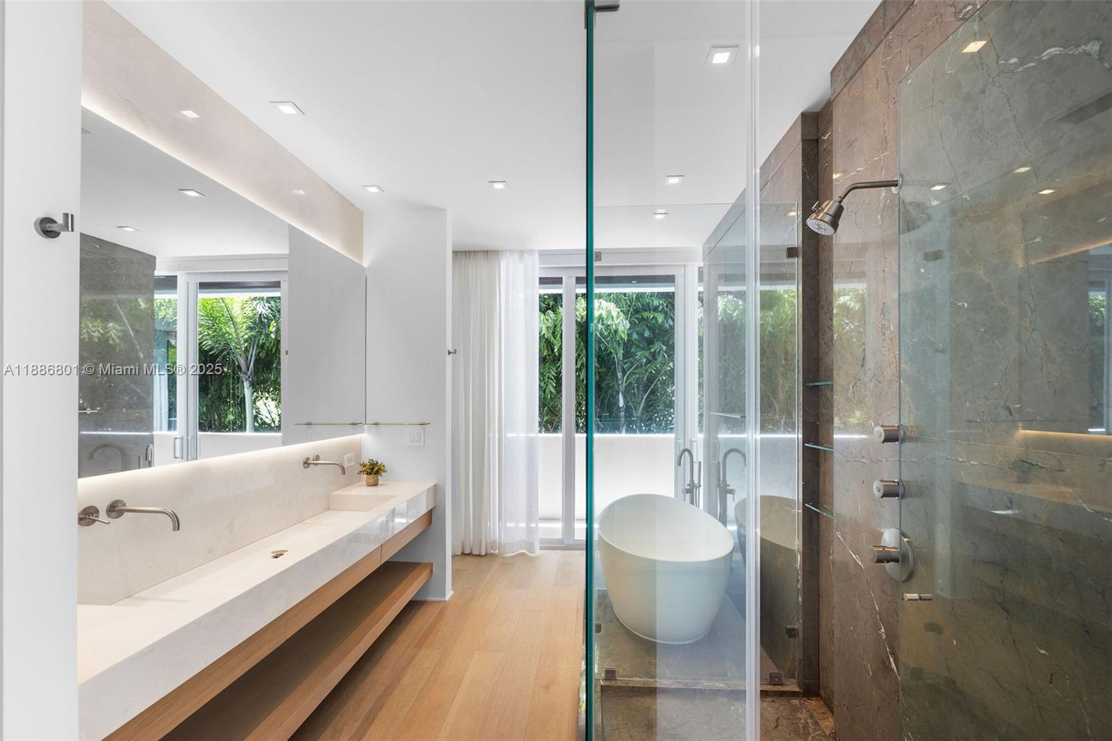 4433 North Bay Road Miami Beach, FL 33140 - Photo 62 of 71 a bathroom with a large tub a toilet and a sink