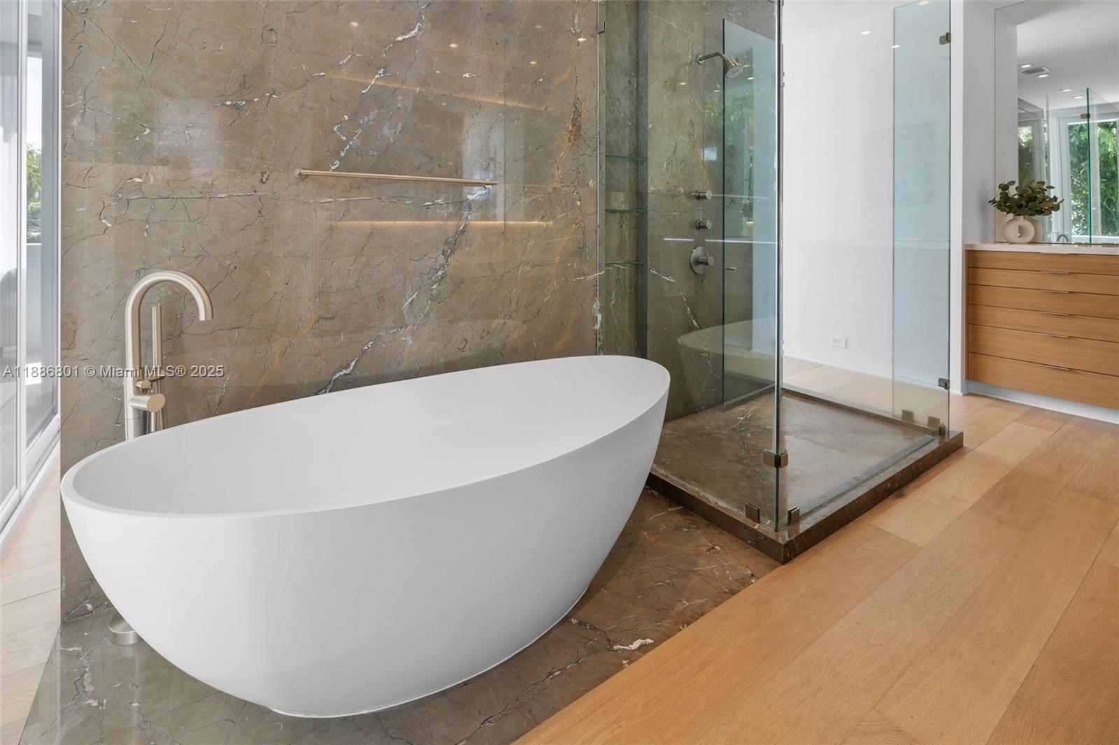 4433 North Bay Road Miami Beach, FL 33140 - Photo 66 of 71 a white bath tub sitting in a bathroom