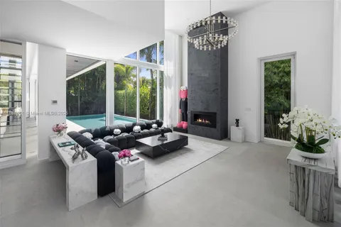 a living room with furniture and potted plants