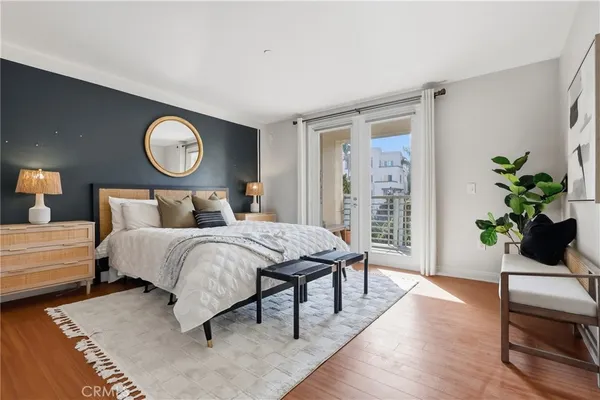 a bedroom with a bed and a potted plant