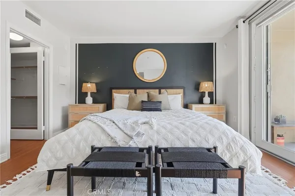 a bedroom with a bed and wooden floor