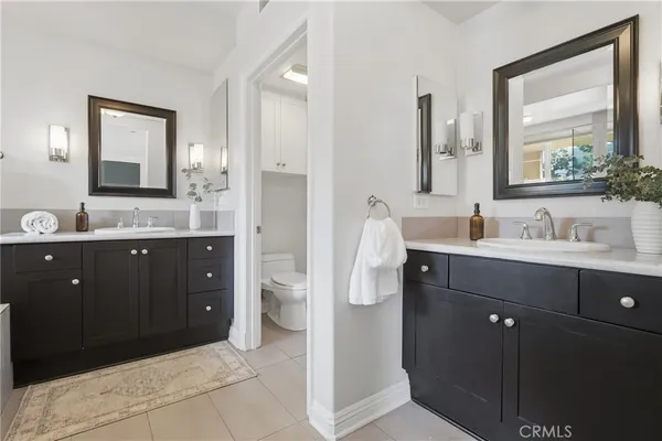 a bathroom with a double vanity sink and mirror