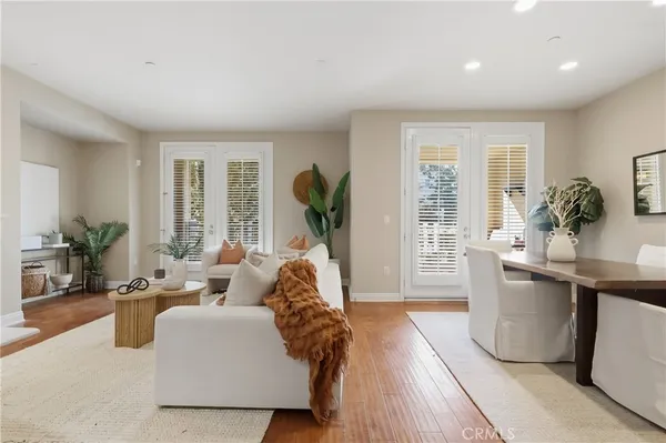 a living room with furniture and large windows