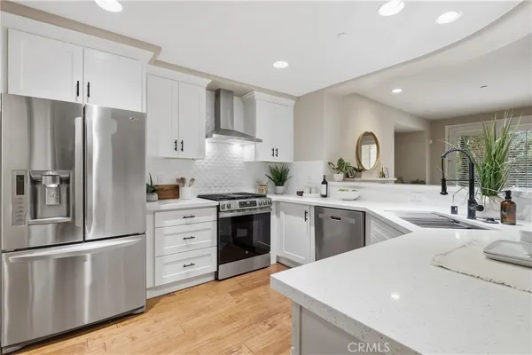 a kitchen with a sink stainless steel appliances and cabinets