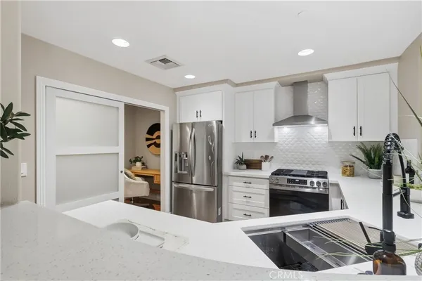 a kitchen with a refrigerator sink and stove