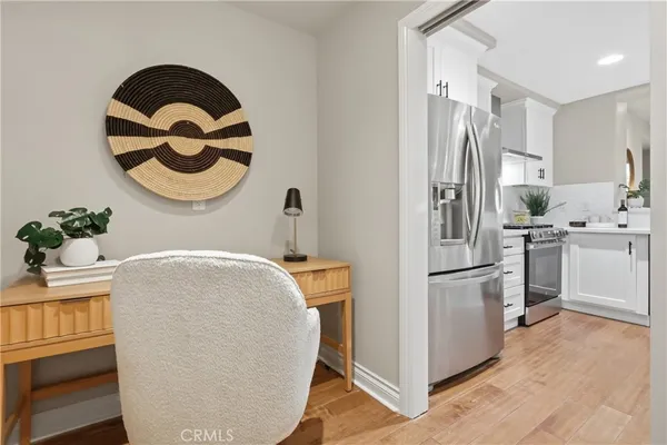 a kitchen with a refrigerator and a stove