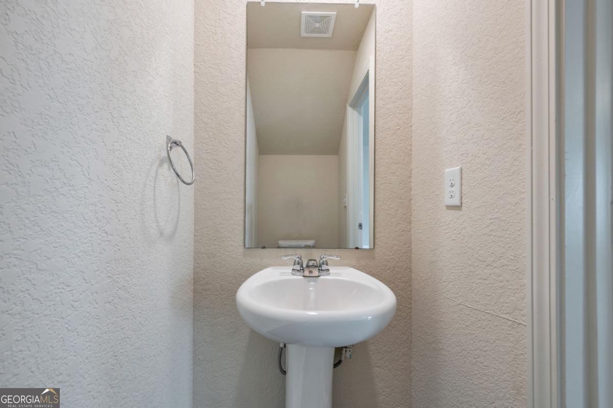 2889 Cleburne Terrace Hampton, GA 30228 - Photo 12 of 25 a bathroom with a sink and a mirror