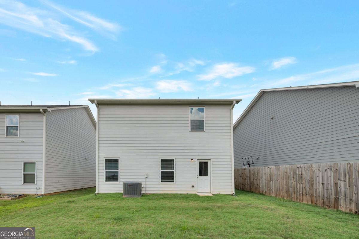 2889 Cleburne Terrace Hampton, GA 30228 - Photo 2 of 25 a view of a house with a backyard