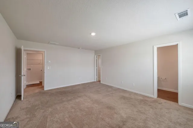 a view of an empty room and closet area