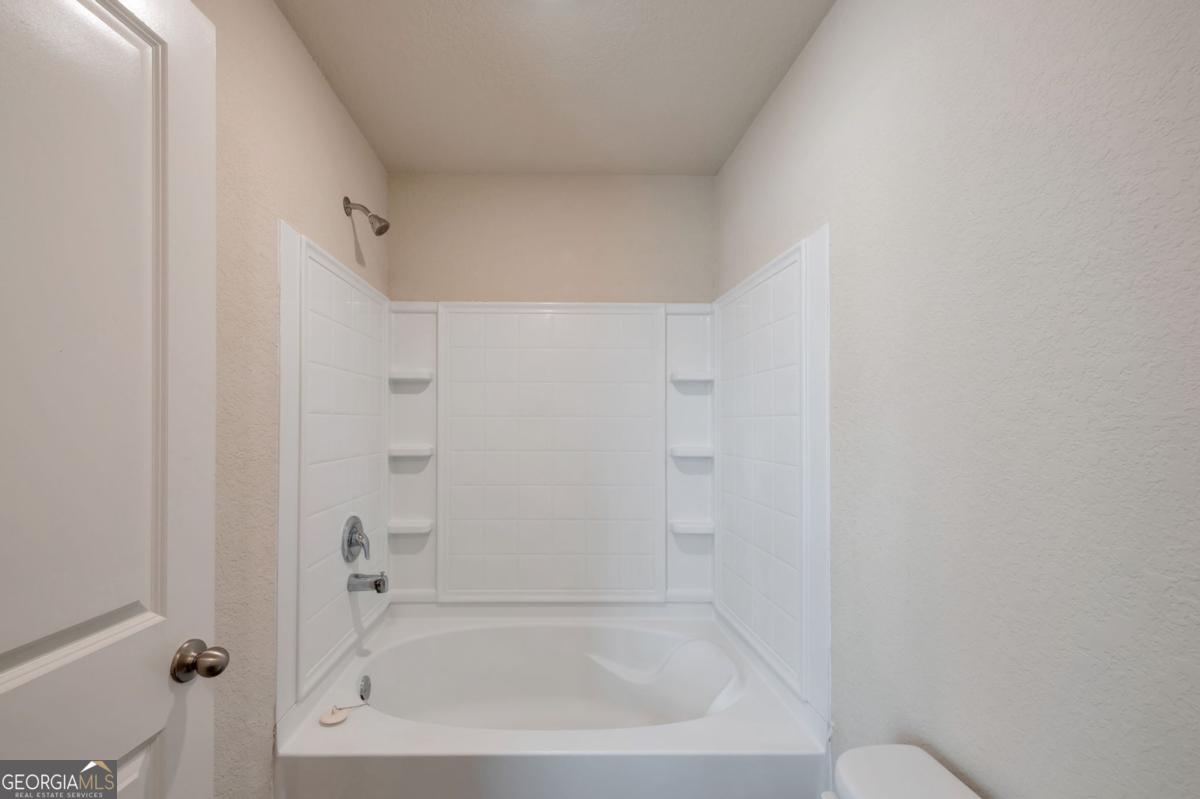 2889 Cleburne Terrace Hampton, GA 30228 - Photo 24 of 25 a bathroom with a bathtub