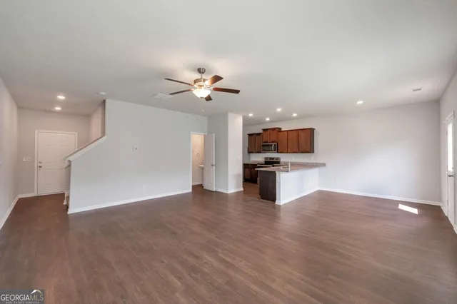a view of kitchen with microwave and refrigerator