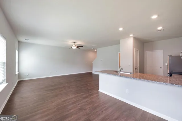 a view of a kitchen with a sink and a large mirror of wooden floor