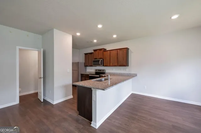 a kitchen with stainless steel appliances granite countertop a stove and a refrigerator