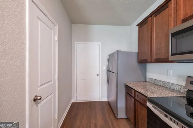 a kitchen with a refrigerator sink and microwave