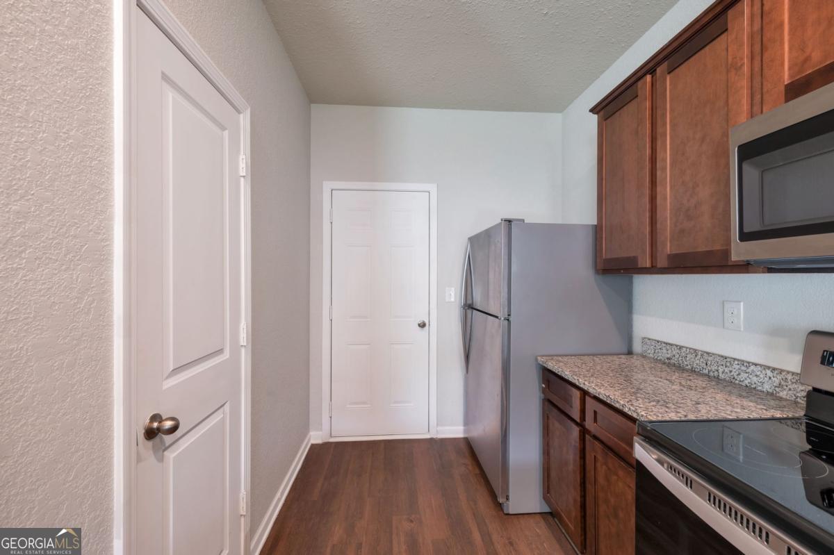 2889 Cleburne Terrace Hampton, GA 30228 - Photo 8 of 25 a kitchen with a refrigerator sink and microwave