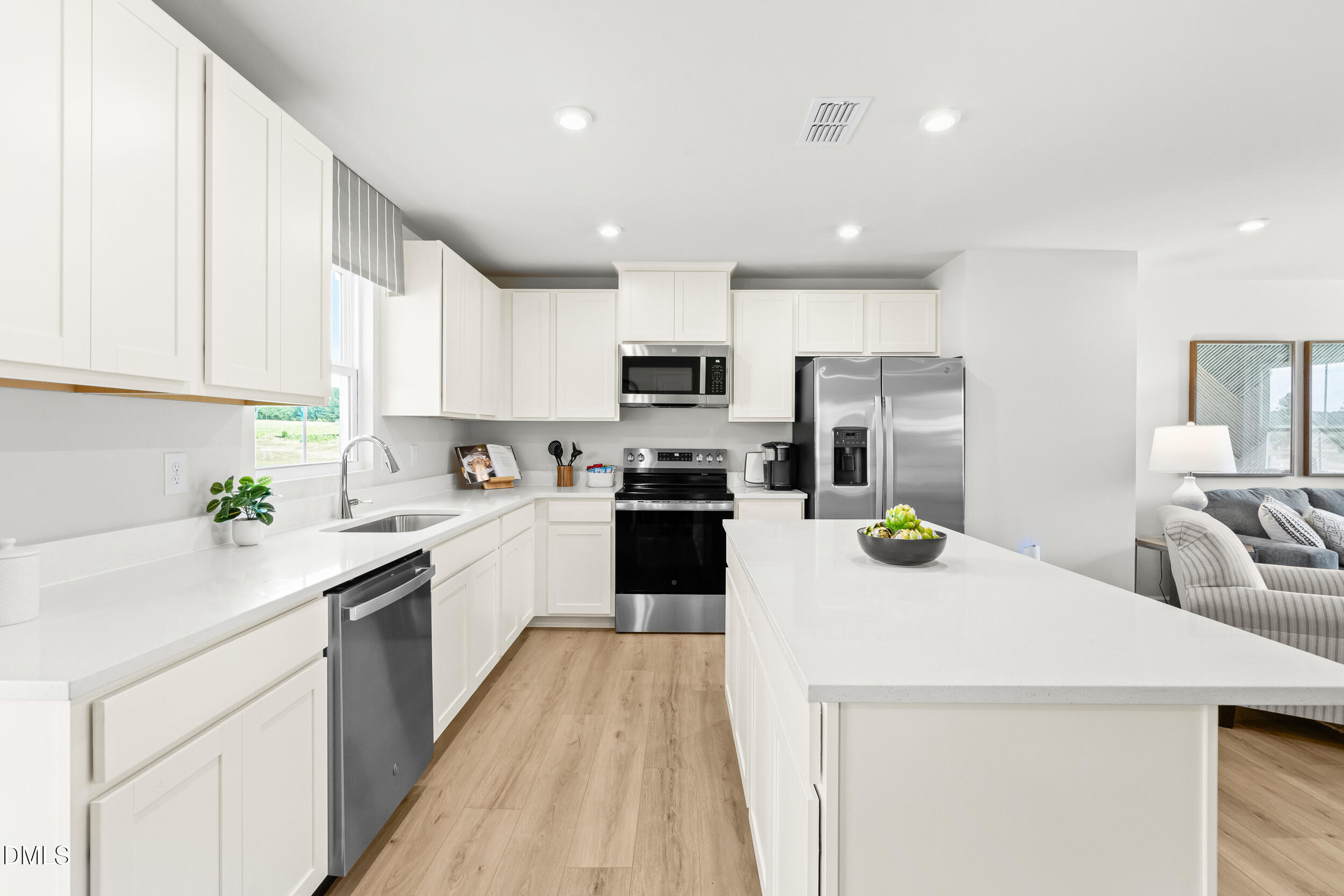 49 Better Day Way Lillington, NC 27546 - Photo 5 of 29 a kitchen with a sink a stove top oven and white kitchen