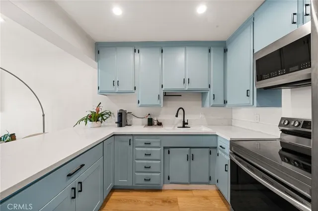 a kitchen with a sink stove and cabinets