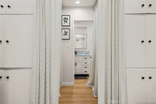 a view of a hallway with wooden shelves