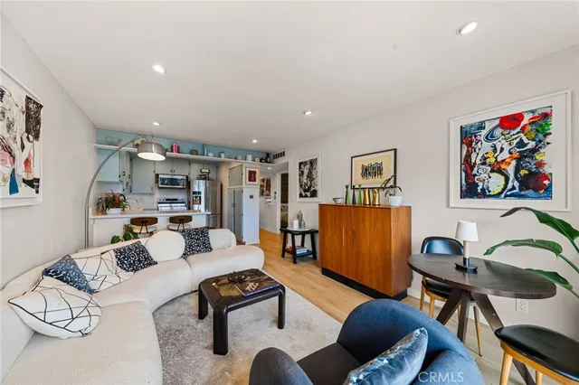 a living room with furniture and a flat screen tv with bookshelf