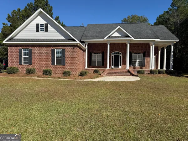 a front view of a house with garden