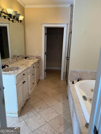 a bathroom with a tub sink and mirror