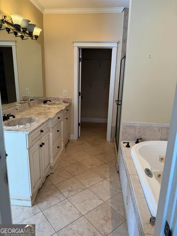 a bathroom with a tub sink and mirror