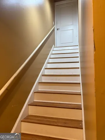 an empty room with wooden floor and closet