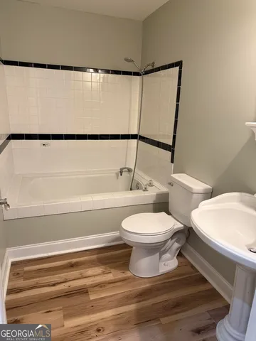 a view of a room with wooden floor