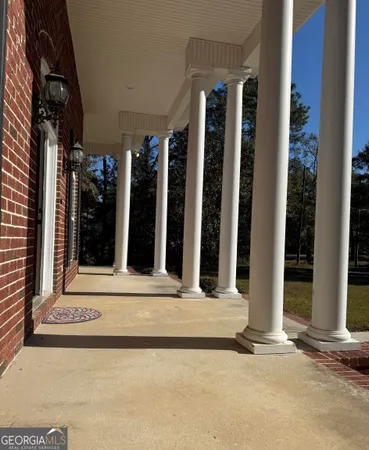 a view of a building with floor to ceiling window and an outdoor space