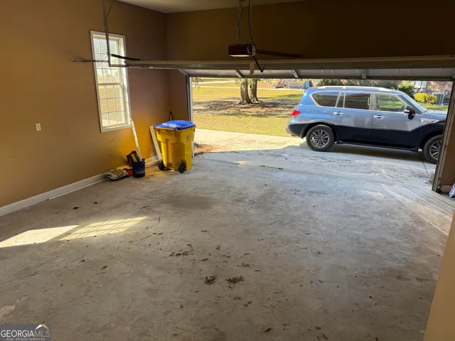 a front view of a house with a yard covered with snow